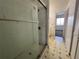 Bathroom with shower, tiled flooring, and access to bedroom at 182 114Th Ne Ter # 182, St Petersburg, FL 33716