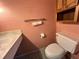 Small bathroom with toilet, sink, and wood cabinet at 182 114Th Ne Ter # 182, St Petersburg, FL 33716