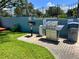 Community grill station with charcoal grills and trash receptacle at 182 114Th Ne Ter # 182, St Petersburg, FL 33716