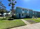 Front view of two-story teal condo with landscaping at 182 114Th Ne Ter # 182, St Petersburg, FL 33716