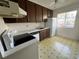Simple kitchen with wood cabinets and appliances at 182 114Th Ne Ter # 182, St Petersburg, FL 33716