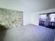 Cozy living room with stone accent wall and sliding door to balcony at 400 N Bayshore Blvd # 104, Clearwater, FL 33759
