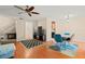 Living room featuring hardwood floors, a TV, and dining area at 11837 Wildeflower Pl, Temple Terrace, FL 33617