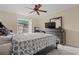Main bedroom with a ceiling fan, dresser, and large bed at 11837 Wildeflower Pl, Temple Terrace, FL 33617