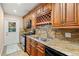 Galley kitchen with granite countertops and wood cabinets at 11837 Wildeflower Pl, Temple Terrace, FL 33617