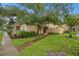 Townhome exterior showcasing landscaping and walkway at 11837 Wildeflower Pl, Temple Terrace, FL 33617