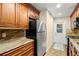 Galley kitchen with granite countertops and wood cabinets at 11837 Wildeflower Pl, Temple Terrace, FL 33617