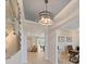 Bright and airy entryway with light hardwood floors and stylish light fixture at 9261 Highland Hills Dr, Hudson, FL 34667