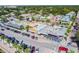 Aerial view of a vibrant neighborhood with colorful houses and shops near a waterfront at 3108 58Th S St, Gulfport, FL 33707