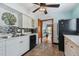 Kitchen with white cabinets, black appliances, and tile backsplash at 3108 58Th S St, Gulfport, FL 33707