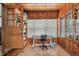 Home office with wood paneling, built-in shelves, and tile flooring at 3108 58Th S St, Gulfport, FL 33707