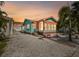 Evening view of teal Florida bungalow with orange awning at 3108 58Th S St, Gulfport, FL 33707