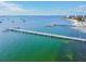 Aerial view of waterfront homes and a pier extending over the calm ocean at 3108 58Th S St, Gulfport, FL 33707