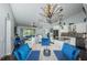 Bright dining room with marble table, blue chairs, and kitchen view at 3345 Crystal E Ct # F, Palm Harbor, FL 34685