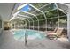 Inviting kidney-shaped pool with screened enclosure at 2517 Trinidad St, Sarasota, FL 34231