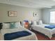 Guest bedroom with two twin beds and modern art at 2517 Trinidad St, Sarasota, FL 34231