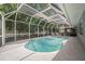 Inviting kidney-shaped pool with screened enclosure at 2517 Trinidad St, Sarasota, FL 34231