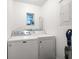 Bright laundry room with Maytag washer and dryer at 2517 Trinidad St, Sarasota, FL 34231