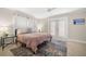 Bedroom with a queen-size bed and French doors leading outside at 2517 Trinidad St, Sarasota, FL 34231