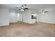 Open living room and kitchen with neutral carpeting at 635 Fairmont Ave # D, Safety Harbor, FL 34695