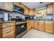 Modern kitchen with stainless steel appliances and light wood cabinets at 865 Maclaren N Dr # D, Palm Harbor, FL 34684
