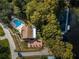 Aerial view showing community pool, clubhouse, and lake access at 865 Maclaren N Dr # D, Palm Harbor, FL 34684