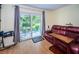 Relaxing living room with leather furniture and view of patio at 865 Maclaren N Dr # D, Palm Harbor, FL 34684
