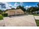 Exterior view of the house with a three car garage at 865 Maclaren N Dr # D, Palm Harbor, FL 34684