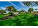 Highland Lakes Club entrance with lush landscaping and flag at 865 Maclaren N Dr # D, Palm Harbor, FL 34684