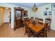 Spacious dining room with antique furnishings and hardwood floors at 865 Maclaren N Dr # D, Palm Harbor, FL 34684