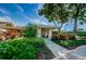 Community clubhouse with landscaping and walkway at 865 Maclaren N Dr # D, Palm Harbor, FL 34684