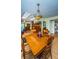 Antique wood dining table and chairs in a bright dining area at 865 Maclaren N Dr # D, Palm Harbor, FL 34684