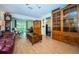 Spacious living room with hardwood floors, built-in shelving and access to patio at 865 Maclaren N Dr # D, Palm Harbor, FL 34684