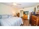 Bright bedroom with a double bed, dresser, and wood floors at 865 Maclaren N Dr # D, Palm Harbor, FL 34684