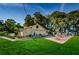 Community clubhouse with outdoor seating and a pool at 865 Maclaren N Dr # D, Palm Harbor, FL 34684