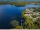 Aerial view of lakefront community with lush green landscape at 865 Maclaren N Dr # D, Palm Harbor, FL 34684