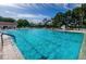 Inviting community pool with plenty of lounge chairs at 865 Maclaren N Dr # D, Palm Harbor, FL 34684