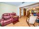 Open living space with leather furniture and view into dining area at 865 Maclaren N Dr # D, Palm Harbor, FL 34684
