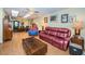 Bright living room with hardwood floors, comfy seating, and a ceiling fan at 865 Maclaren N Dr # D, Palm Harbor, FL 34684