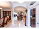 Elegant hallway with views into game room and dining area at 19003 Apian Way, Lutz, FL 33558