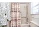 Bathroom featuring tub, shower, and striped curtain at 602 Quail Keep Dr, Safety Harbor, FL 34695