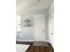 Bright entryway with dark hardwood floors, decorative shelves, and a white door at 1301 22Nd N Ave, St Petersburg, FL 33704