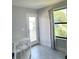 Bright bedroom with white table and chair, and access to balcony at 1301 22Nd N Ave, St Petersburg, FL 33704