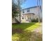 Landscaped backyard with a two-story home and palm trees at 1301 22Nd N Ave, St Petersburg, FL 33704