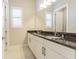 Bathroom with double vanity, granite countertop and white cabinets at 17705 Lucaya Dr, Bradenton, FL 34202