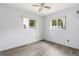 Bedroom with grey tile floors and ceiling fan at 18053 2Nd E St, Redington Shores, FL 33708