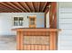 Covered back patio with wooden bar and access door at 18053 2Nd E St, Redington Shores, FL 33708