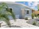 Front view of a light blue house with a brick walkway at 18053 2Nd E St, Redington Shores, FL 33708