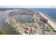 Aerial view of a house by the bay, close to beach and other houses at 18053 2Nd E St, Redington Shores, FL 33708