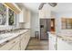 White kitchen with granite countertops and stainless appliances at 18053 2Nd E St, Redington Shores, FL 33708